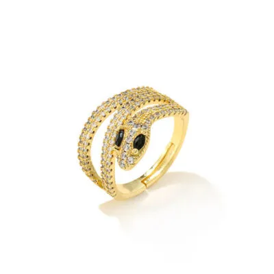 Bague dorée en forme de serpent enroulé, sertie de pierres claires et yeux noirs