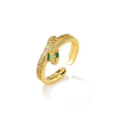 Bague dorée en forme de serpent avec yeux verts et pierres claires